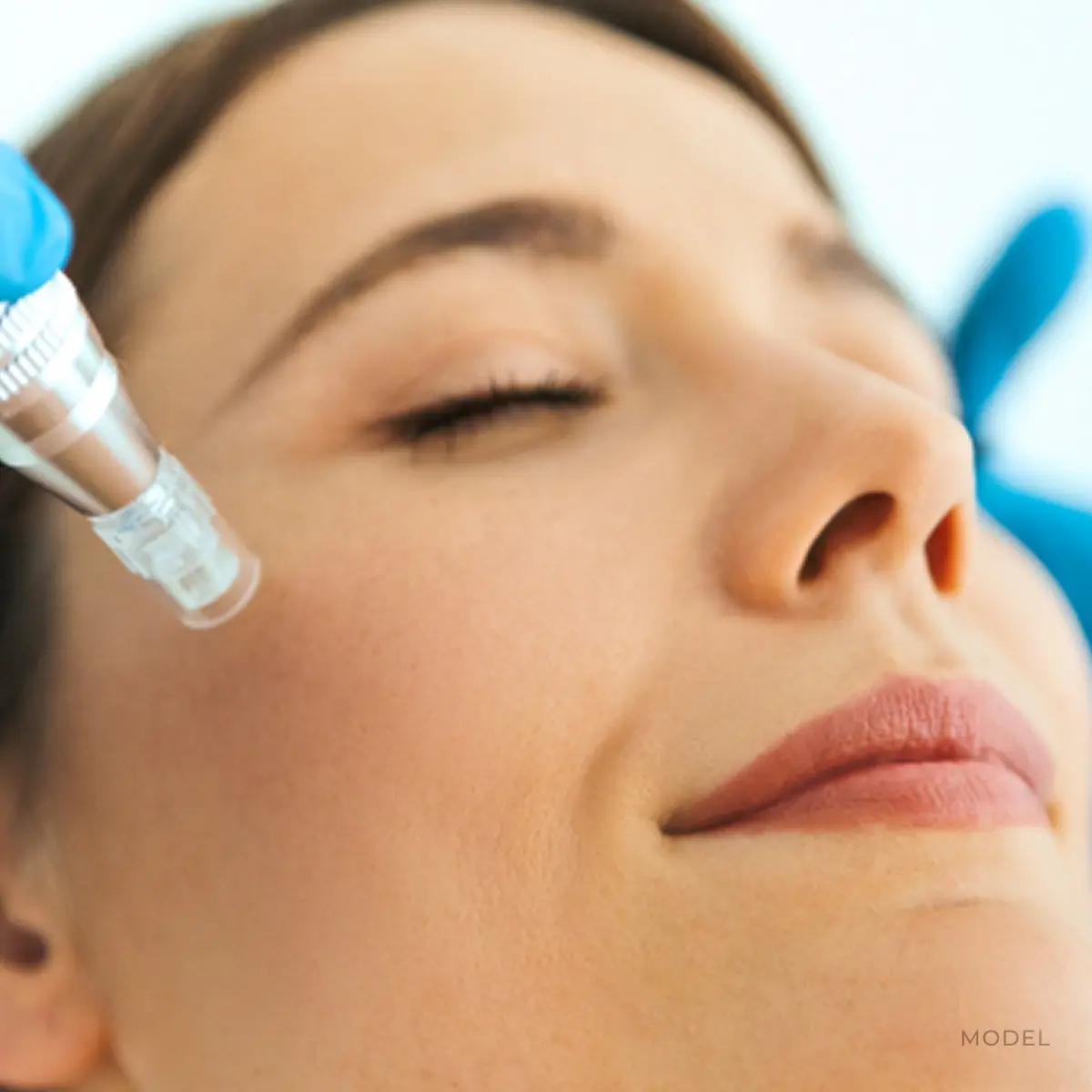 Woman receiving facial treatment