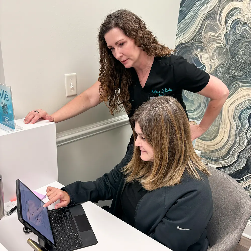 Malissa LaRoche, owner and physician assistant injector, at front desk with staff