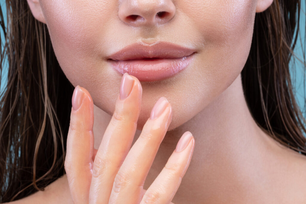 Close up of woman touching healthy hydrated lips